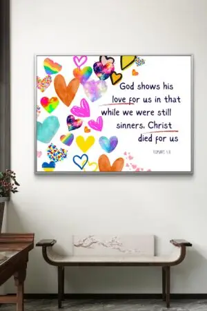 Christian wall art featuring Romans 5:8 with colorful heart icons, symbolizing God’s unconditional love through Christ’s sacrifice.